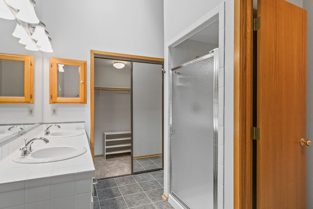 bathroom with tile patterned floors, a shower with shower door, and vanity