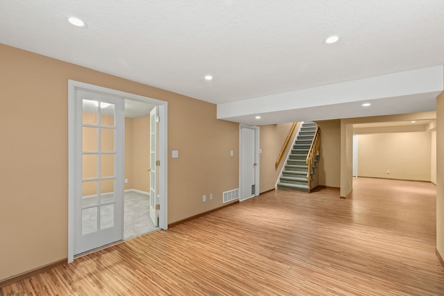 interior space featuring a textured ceiling and light hardwood / wood-style flooring