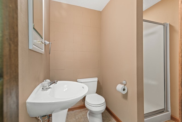 bathroom with toilet and a shower with door