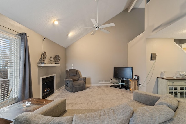 living room with ceiling fan, high vaulted ceiling, carpet, and a wealth of natural light