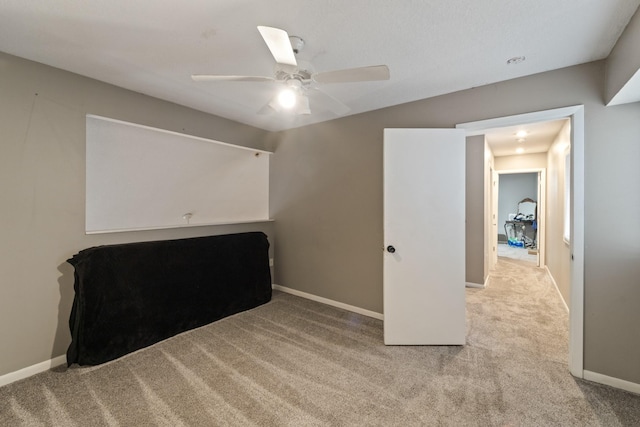 unfurnished bedroom featuring light carpet and ceiling fan