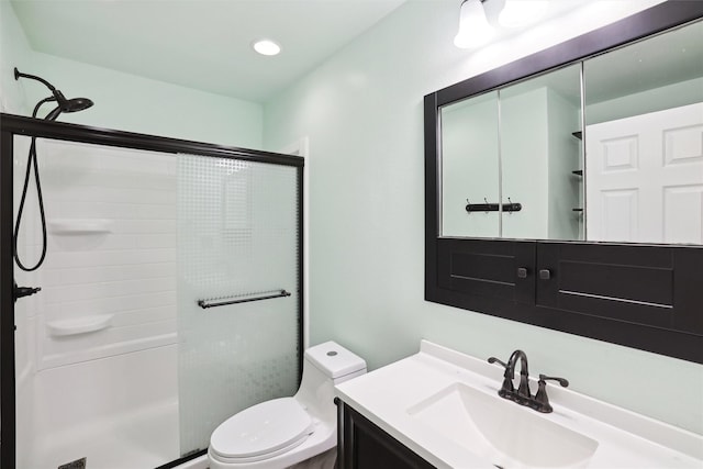 bathroom with vanity, an enclosed shower, and toilet