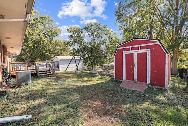 view of yard featuring a storage shed and a deck