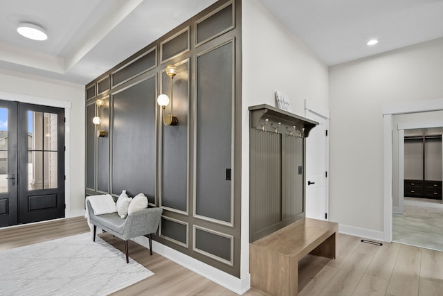 mudroom with light wood finished floors, french doors, recessed lighting, and baseboards