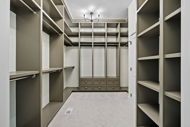 walk in closet featuring visible vents and carpet flooring