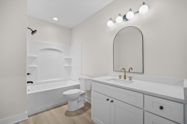 full bath with shower / washtub combination, toilet, vanity, wood finished floors, and baseboards