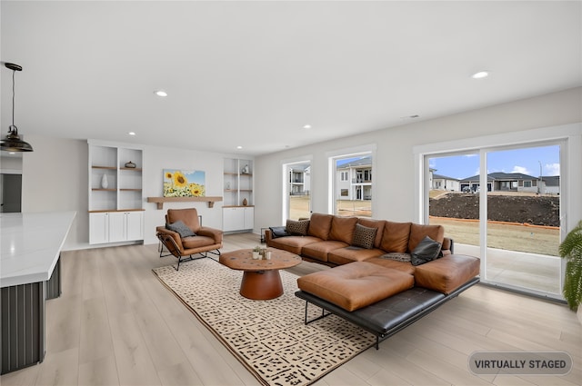 living room featuring recessed lighting, visible vents, and light wood-style flooring