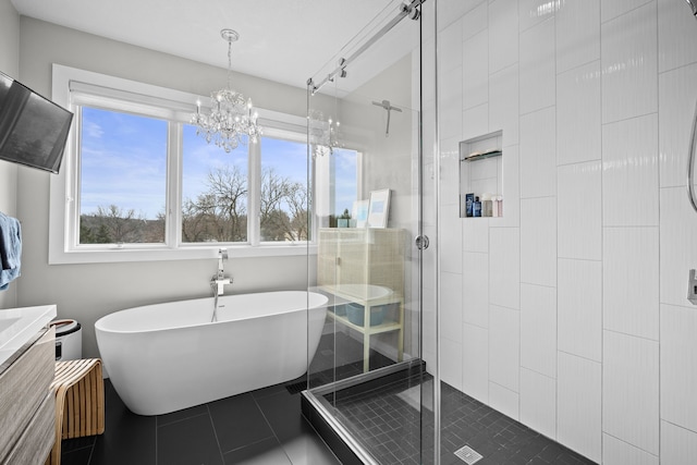 full bathroom featuring tile patterned floors, a freestanding tub, vanity, and a shower stall