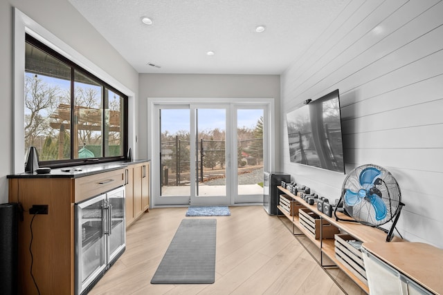 entryway featuring recessed lighting, visible vents, a textured ceiling, and light wood-style flooring