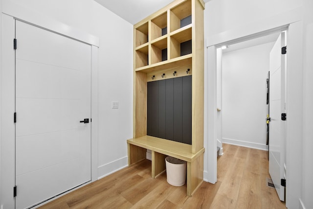 mudroom featuring baseboards and light wood-style flooring