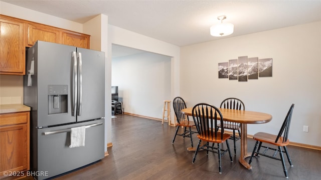 dining area with dark hardwood / wood-style flooring