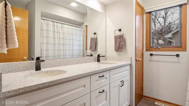 bathroom with a shower with curtain and vanity