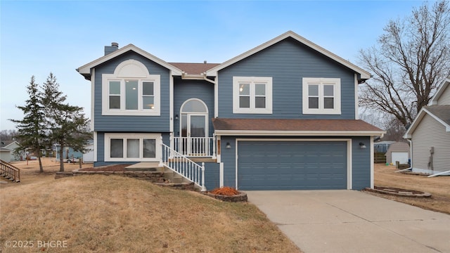 bi-level home featuring a garage and a front yard