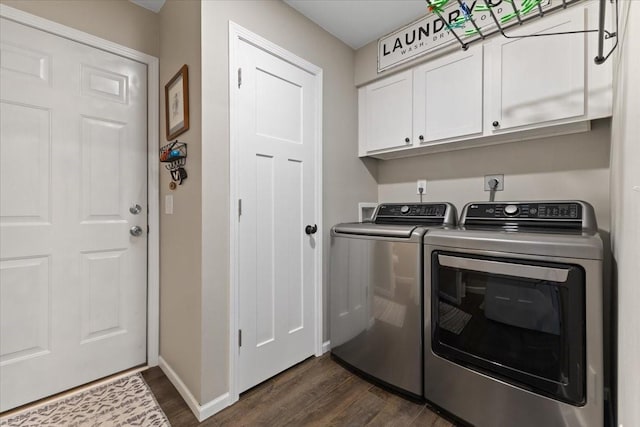 laundry room featuring dark wood-type flooring, cabinets, and washing machine and clothes dryer