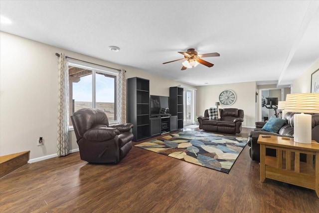 living room with dark wood-type flooring and ceiling fan