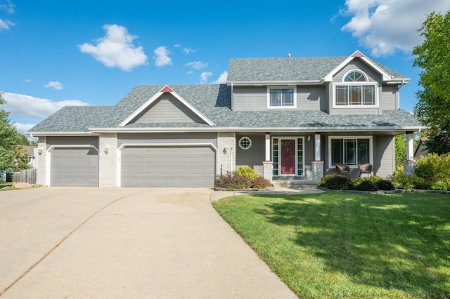 view of front of property with a garage, a front yard, and covered porch