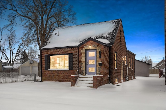 view of front of property featuring a garage and an outdoor structure