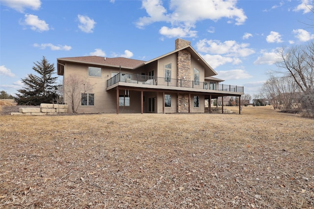 rear view of property featuring a deck