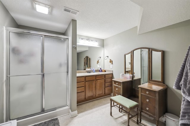 6805 Aubrey Ct, Johnston, IA 50131 - bathroom with a shower stall, vanity, and a textured ceiling