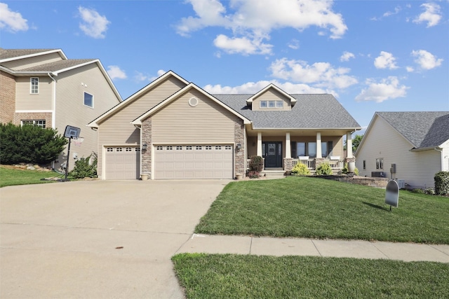 6805 Aubrey Ct, Johnston, IA 50131 - craftsman-style house with covered porch, driveway, a garage, a front yard, and stone siding