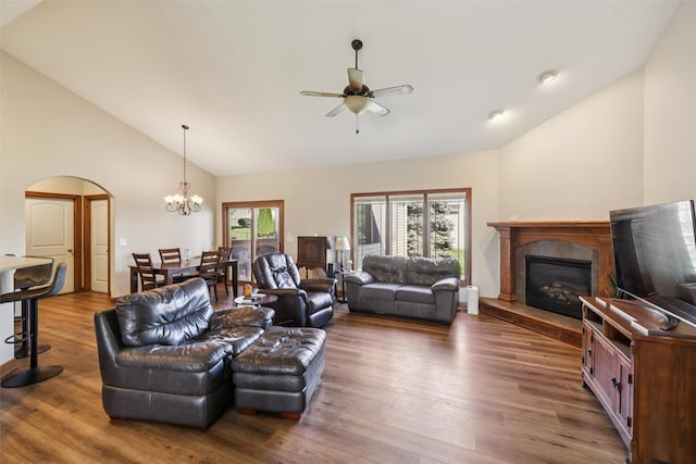 6805 Aubrey Ct, Johnston, IA 50131 - living area with a tile fireplace, a ceiling fan, arched walkways, wood finished floors, and a chandelier