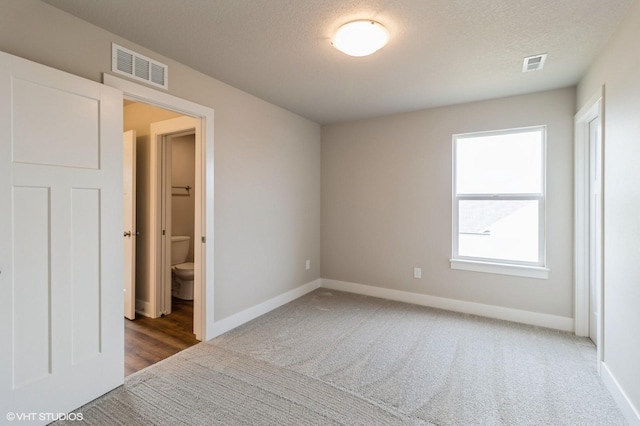 15019 Springbrook Trl, Urbandale, IA 50323 - unfurnished bedroom with carpet floors and a textured ceiling