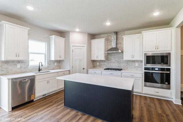 15019 Springbrook Trl, Urbandale, IA 50323 - kitchen with appliances with stainless steel finishes, wall chimney range hood, a center island, white cabinetry, and light countertops