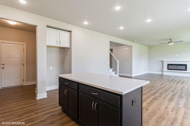 15019 Springbrook Trl, Urbandale, IA 50323 - kitchen featuring white cabinetry, ceiling fan, wood finished floors, a center island, and light countertops