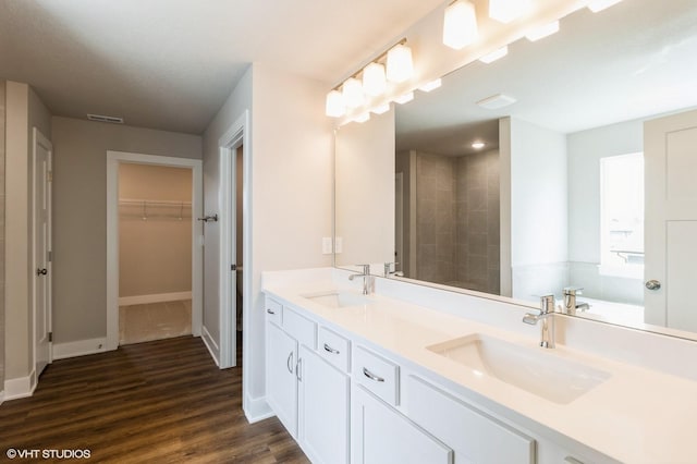 15019 Springbrook Trl, Urbandale, IA 50323 - full bath featuring double vanity, wood finished floors, a walk in closet, and tiled shower