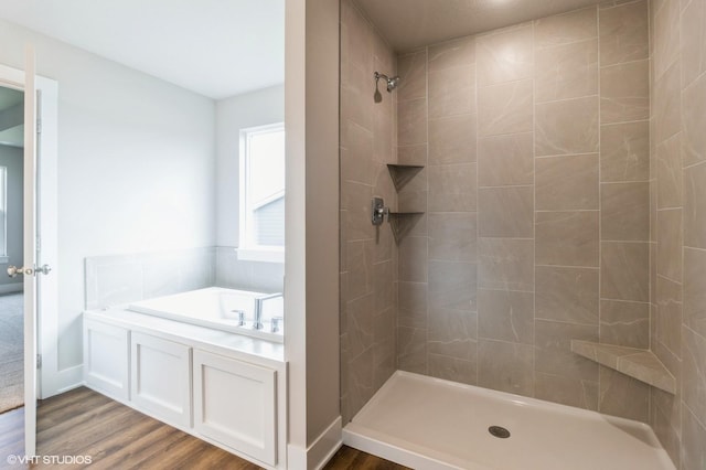 15019 Springbrook Trl, Urbandale, IA 50323 - full bathroom with wood finished floors, tiled shower, and a garden tub