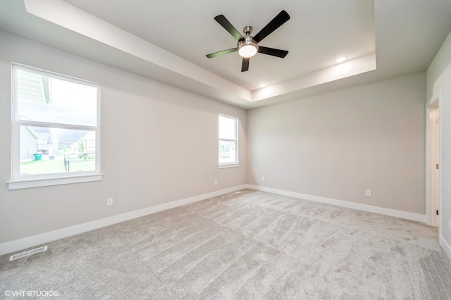 15015 Springbrook Trl, Urbandale, IA 50323 - unfurnished room featuring a ceiling fan, recessed lighting, carpet, and a tray ceiling