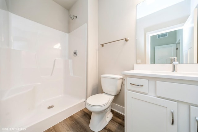 15015 Springbrook Trl, Urbandale, IA 50323 - full bathroom with vanity, wood finished floors, and a shower