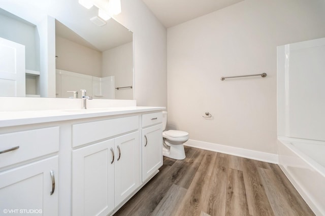 15015 Springbrook Trl, Urbandale, IA 50323 - bathroom with vanity, wood finished floors, and tub / shower combination
