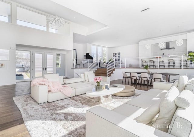 1167 S Wilder Pl, West Des Moines, IA 50266 - living room featuring wood finished floors, french doors, and a chandelier