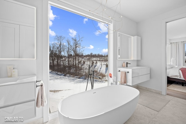 1167 S Wilder Pl, West Des Moines, IA 50266 - bathroom featuring a freestanding bath, ensuite bathroom, vanity, and a chandelier
