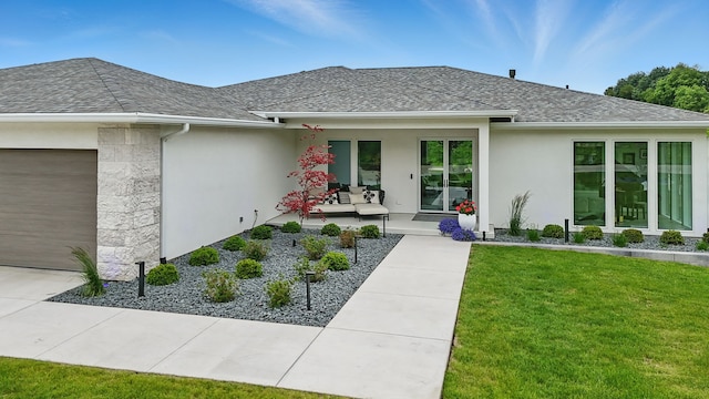 1167 S Wilder Pl, West Des Moines, IA 50266 - entrance to property with a garage, stucco siding, a shingled roof, and a lawn