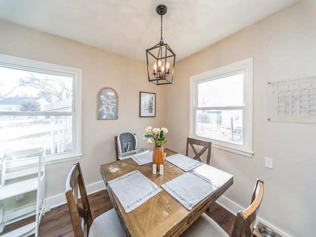 dining area with an inviting chandelier and dark wood-type flooring