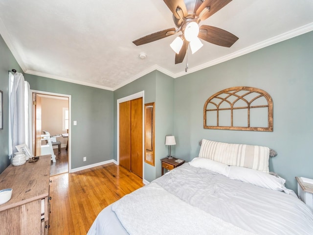 bedroom featuring ornamental molding, ceiling fan, and light wood-type flooring