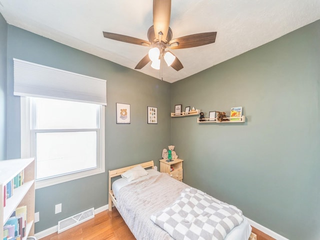 bedroom with light hardwood / wood-style flooring and ceiling fan