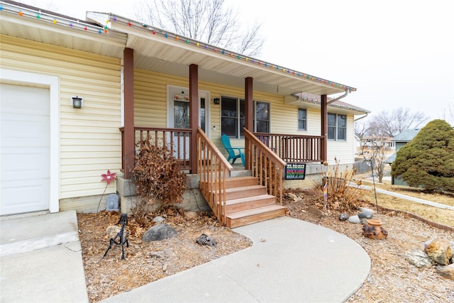 view of front of house with a garage and covered porch