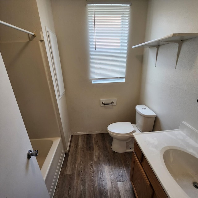 full bathroom featuring vanity, bathing tub / shower combination, hardwood / wood-style floors, and toilet