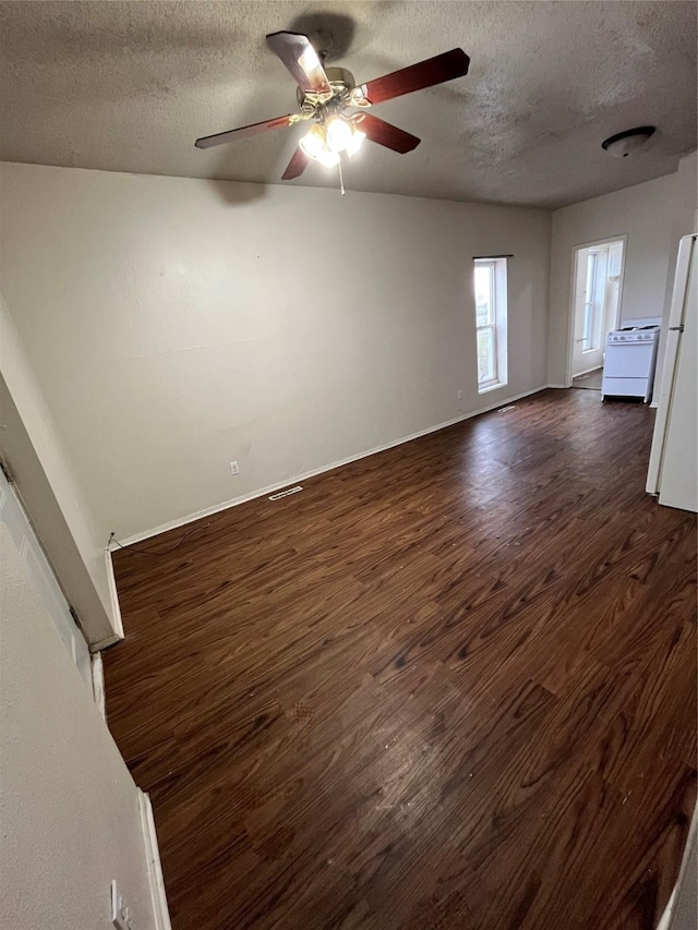 interior space with ceiling fan, dark wood-type flooring, and a textured ceiling