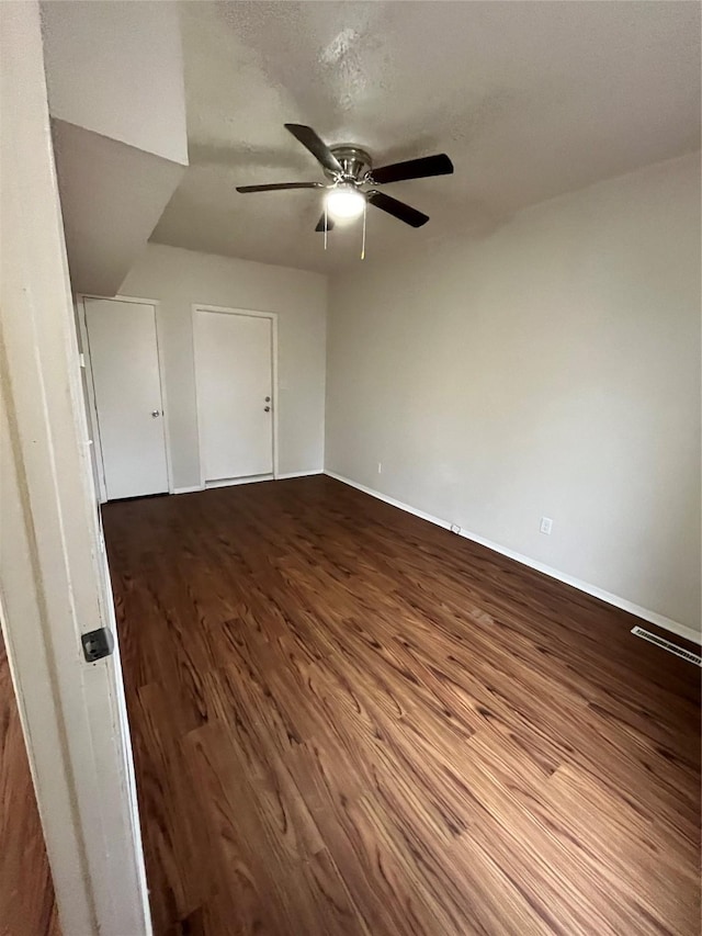 spare room with hardwood / wood-style flooring, ceiling fan, and a textured ceiling