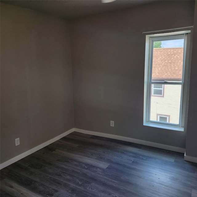 empty room featuring dark wood-type flooring