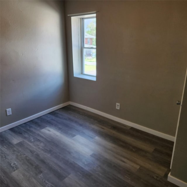 empty room with dark hardwood / wood-style floors