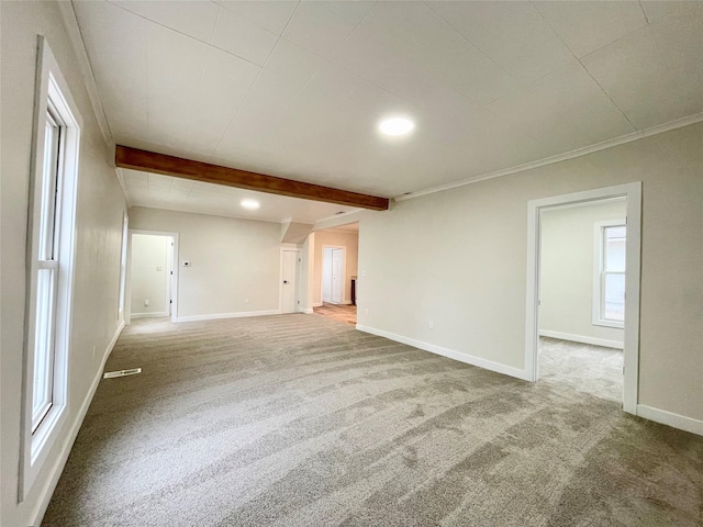 unfurnished living room featuring crown molding, carpet flooring, and beam ceiling