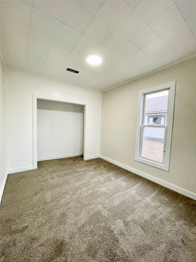 unfurnished bedroom with carpet floors and a closet