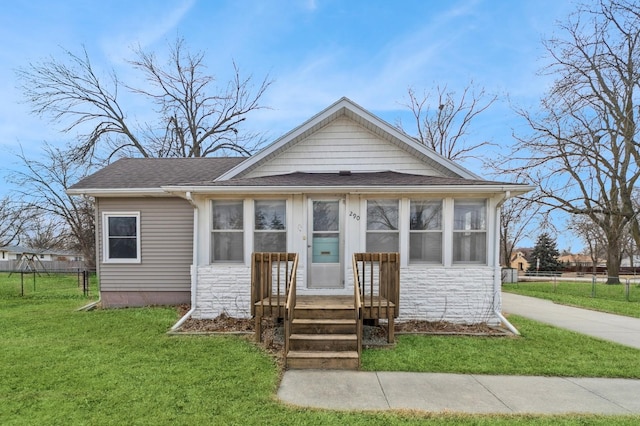 bungalow-style house featuring a front yard