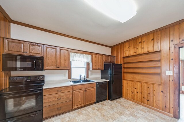 kitchen featuring ornamental molding, light countertops, brown cabinets, a sink, and black appliances