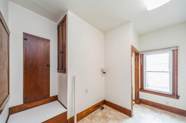 corridor featuring baseboards